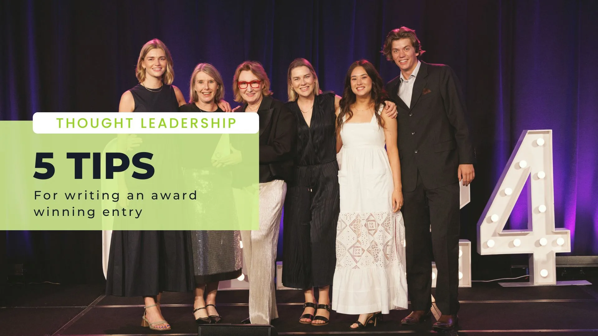 Photo of 6 people on stage. Green box overlay reading: Thought Leadership, 5 tips for writing an award winning entry.