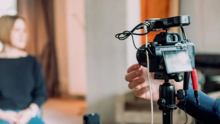 Person being filmed for interview. person sitting down behind professional camera