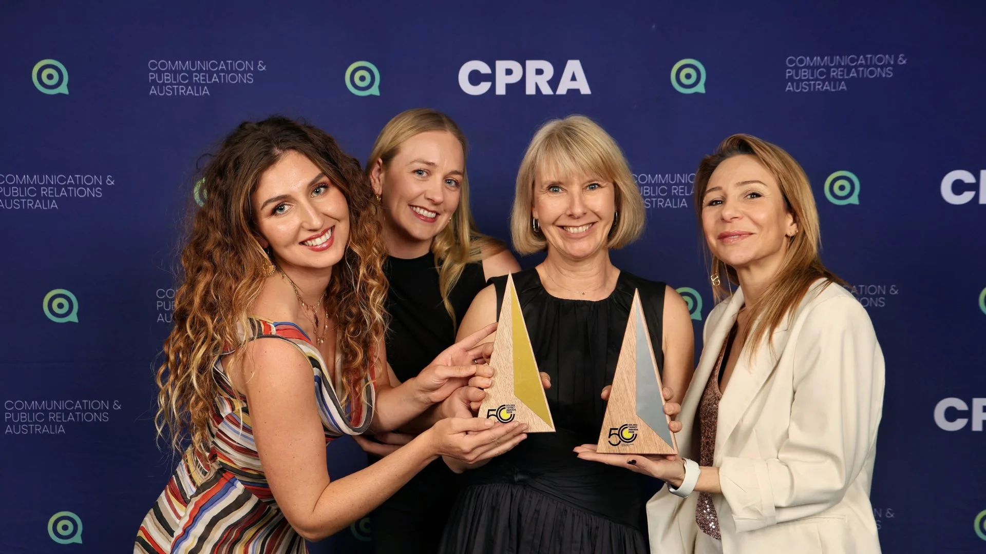 Cube team celebrating two awards at the 2026 Golden Target Awards.